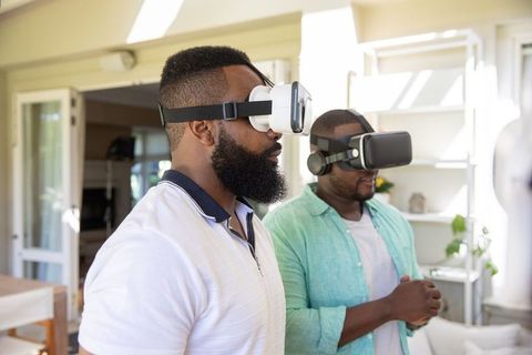 Two Friends Exploring Virtual Reality in Modern Living Space