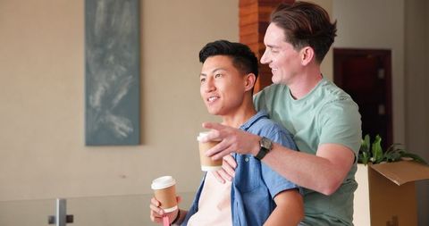 Happy Gay Couple Sharing Coffee at Home, Embracing Lifestyle