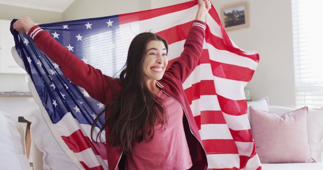 Happy caucasian woman sitting on couch with flag of usa and watching tv in living room - Download Free Stock Photos Pikwizard.com