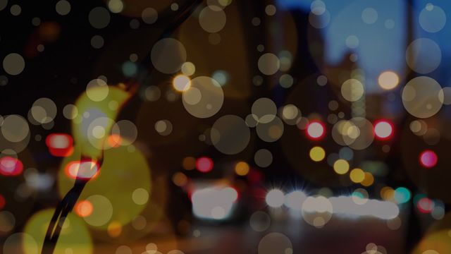 Bokeh effect with overlapping lights and hints of a city in background captures urban ambiance. Ideal for digital projects needing an abstract or artistic design, such as fashion interfaces or modern graphic designs. Useful in presentations where mood and creativity are key themes.