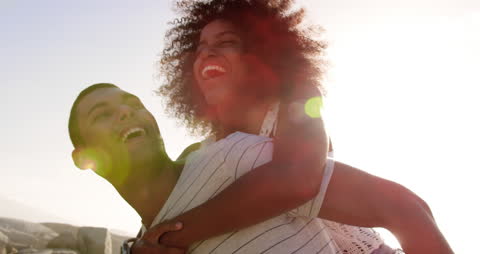 Cheerful Couple Enjoying Playful Beach Moment
