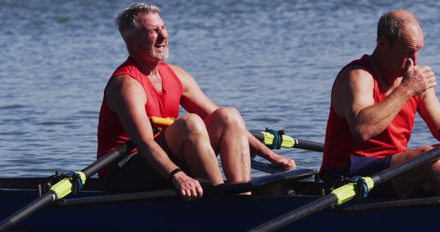 Middle-aged men are rowing in a boat on a sunny day with focused expressions and coordinated movements. Perfect for themes related to sports, teamwork, outdoor activities, fitness, and perseverance.