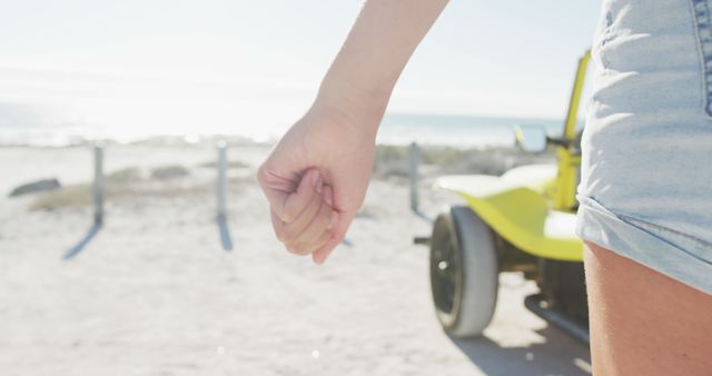 Close-Up of Person's Hand and Beach Buggy Near Seaside - Download Free Stock Images Pikwizard.com