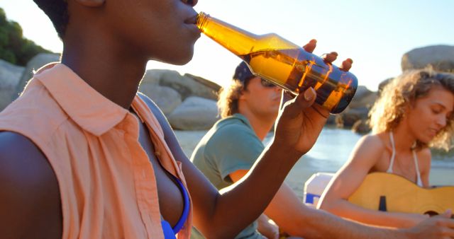 Group of Friends Relaxing on Beach Tasting Beer During Sunset - Download Free Stock Images Pikwizard.com