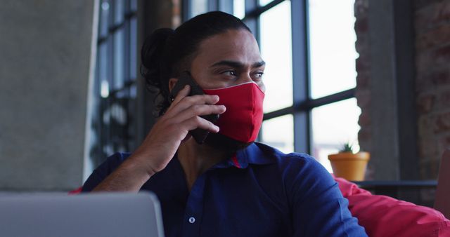 Person in Red Mask Making Phone Call in Modern Office - Download Free Stock Images Pikwizard.com