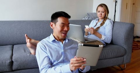 Couple Engaging with Digital Devices at Home