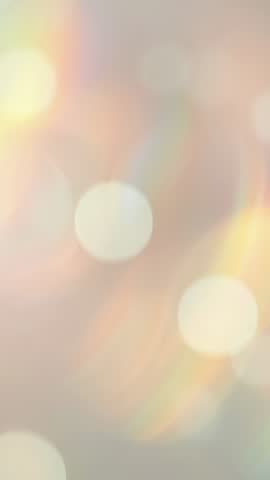 Looping bokeh lights over pastel gradient vertical video, dreamy abstract background