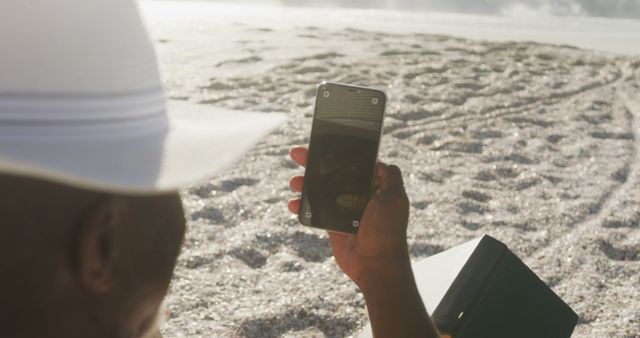 Relaxing on Beach Checking Phone Reflecting, Close-Up at Sunset - Download Free Stock Images Pikwizard.com