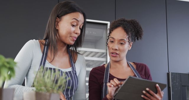 African American Women Cooking and Using Digital Tablet in Modern Kitchen - Download Free Stock Images Pikwizard.com