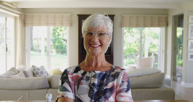 Smiling Senior Woman in Modern Living Room with Large Windows - Download Free Stock Images Pikwizard.com