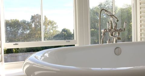 Sunlit Bathroom with Modern Faucet and Scenic Outdoor View