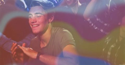 Joyful Man Enjoying Nightlife at Club with Colorful Lights