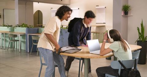 African American students collaborating at roundtable in modern coworking study lounge
