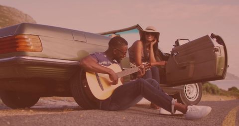 couple enjoying outdoor guitar session by convertible - Download Free Stock Images Pikwizard.com