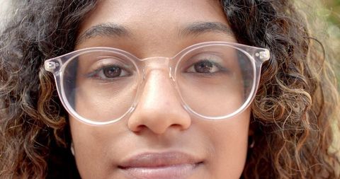 Teen Girl with Curly Hair Wearing Clear Glasses, Calm Expression