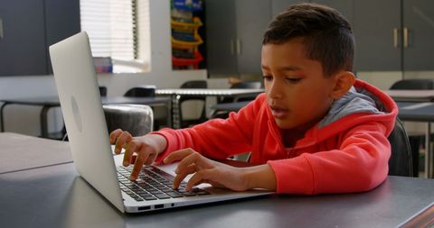 Focused Child Learning on Laptop in Classroom - Download Free Stock Images Pikwizard.com