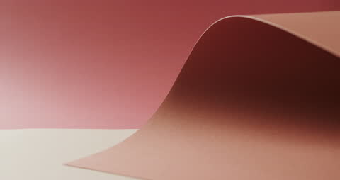 Close Up of Rolled Paper Sheets on Red Gradient Background