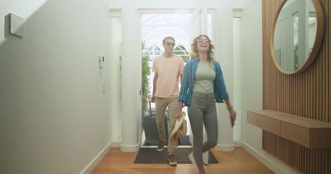 Joyful Couple Returning Home with Luggage from Travel