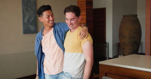 Happy Gay Couple Cheerfully Embracing at Home
