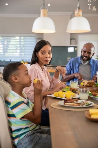 Family relations enjoying meal in contemporary kitchen