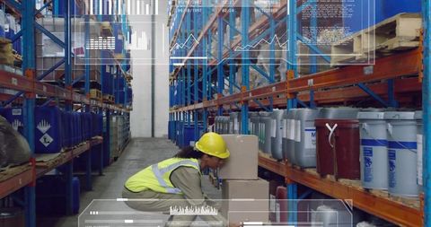 Warehouse worker wearing yellow hardhat handling boxes in blue racking with hud overlay