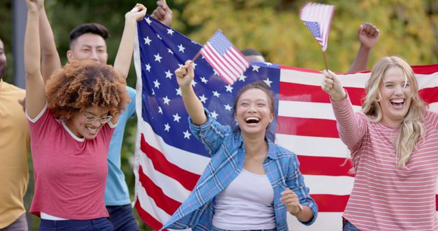 Diverse group of friends celebrating with American flags outdoors - Download Free Stock Images Pikwizard.com