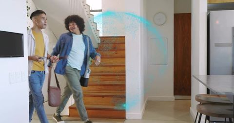 Young friends walking into modern home carrying bags with blue digital arc entrance