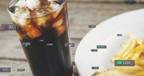 Sparkling glass of cola with ice and rustic fries with social media notification overlays