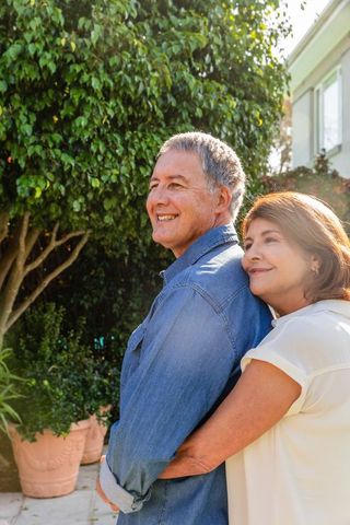 Senior couple enjoying leisurely moment in sunny backyard