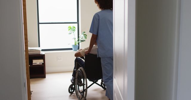 Healthcare Worker Assisting Patient in Wheelchair in Bright Room - Download Free Stock Images Pikwizard.com