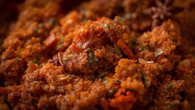 Spiced carrot crumb mix with herbs and warm indian masala macro closeup rustic texture
