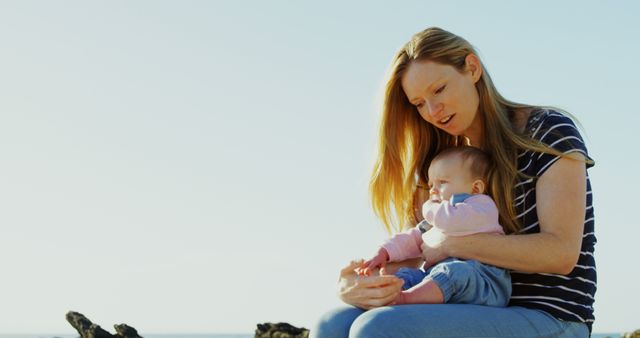 Mother Holding Child Outdoors At Beach With Sunny Sky - Download Free Stock Images Pikwizard.com