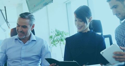 Business Professionals Collaborating at Office with Documents and Tablet
