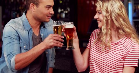 Young Friends Toasting with Beer Glasses at a Bar - Download Free Stock Images Pikwizard.com