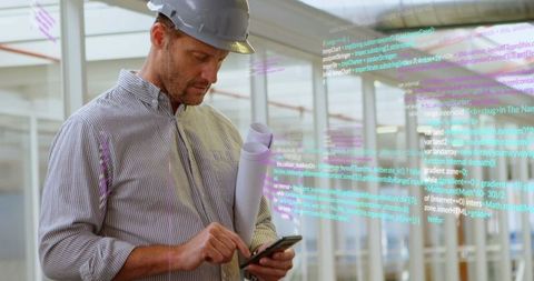 Engineer Using Smartphone with Digital Code Overlay