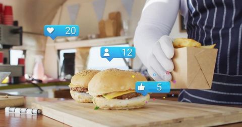 Food Truck Vendor Handling Burgers and Takeaway Box