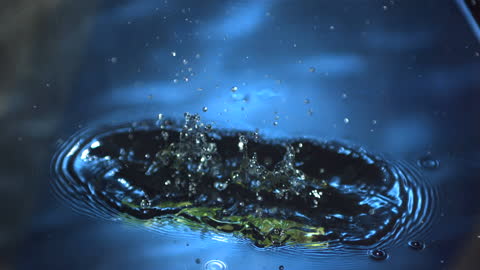 Asparagus Falling into Blue Water Slow Motion Splash