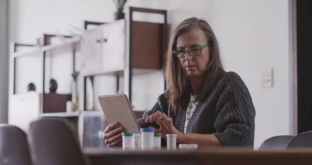 Older Woman Using Tablet in Office with Medical Supplies - Download Free Stock Images Pikwizard.com