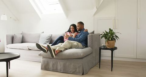 Joyful Couple Celebrating Pregnancy News in Cozy Home Setting