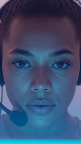 Vertical video showing focused woman wearing headset mic glowing from monitor, gaming stream