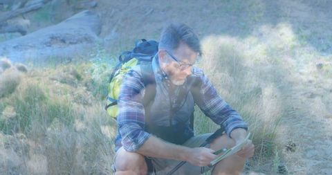 Hiker Navigating Trail Using Map in Mountain Wilderness