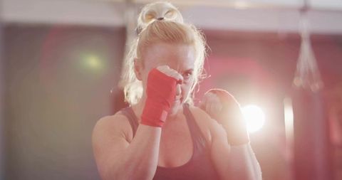 Female Boxer in Gym Practicing Punching Activity