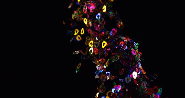 Close-up of confetti falling from the top. Multicolored confetti against black background, celebration concept 4k