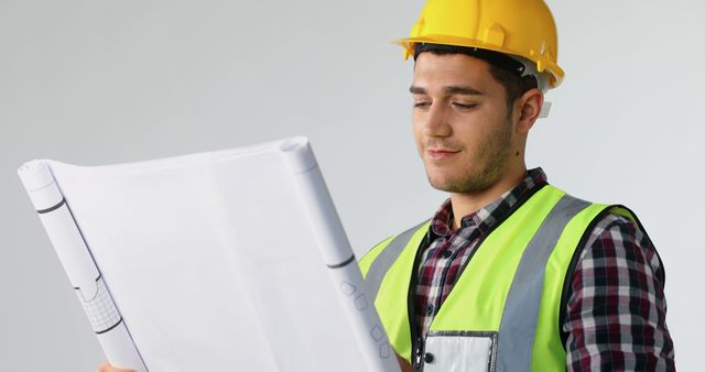 Male Construction Engineer Reviewing Blueprints with Confidence - Download Free Stock Images Pikwizard.com