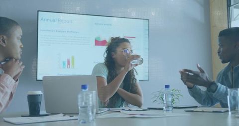 Diverse Team Collaborating While Analyzing Reports in Modern Conference Room