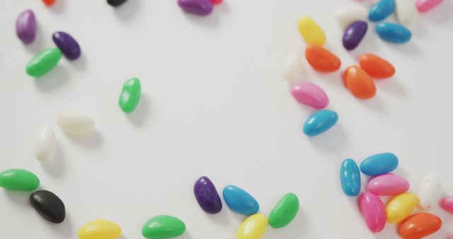 Assortment of Vibrant Jelly Beans on White Surface - Download Free Stock Images Pikwizard.com