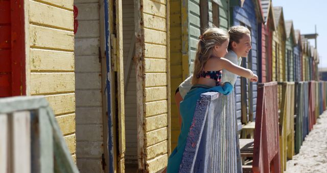 Two Girls Enjoying Summer at Colorful Beach Cabins - Download Free Stock Images Pikwizard.com