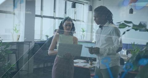 Colleagues Collaborating at Office with Laptop and Comparative Analytics