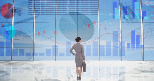 Businesswoman Analyzing Virtual Financial Data on Office Window - Download Free Stock Images Pikwizard.com