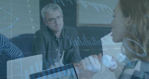 Business Team Collaborating Around Augmented Data Dashboards on Tablet and Laptop